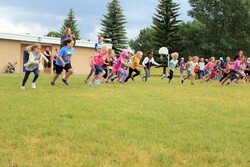 Students running in a foot race at elementary sports day